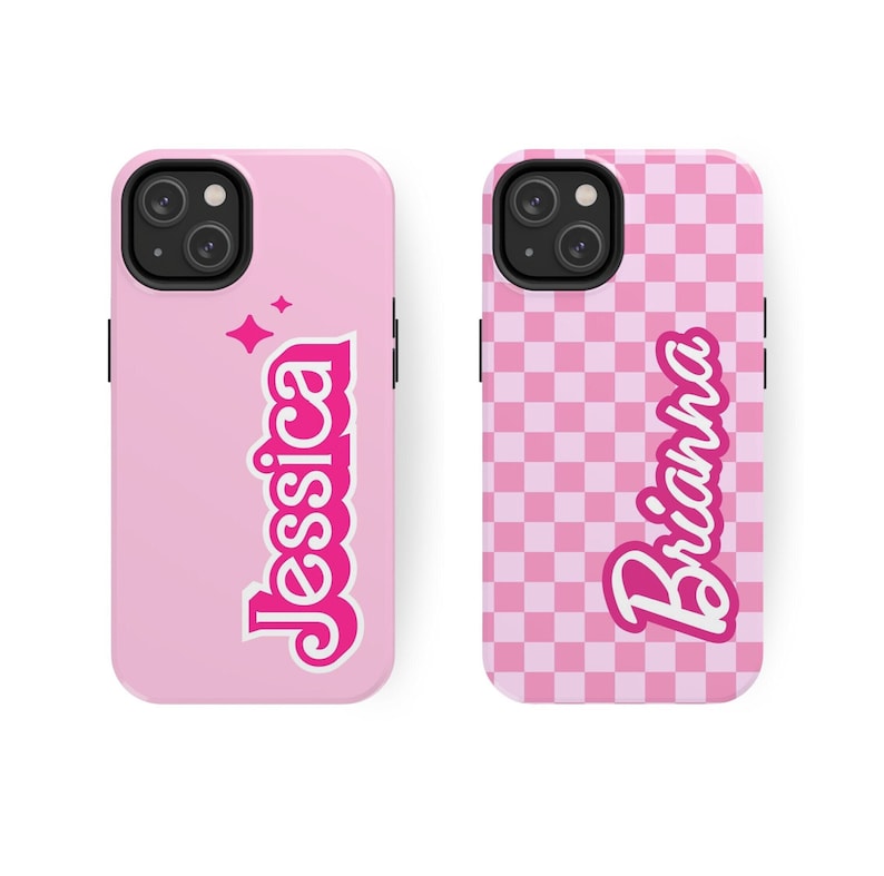 May include: Two pink phone cases with different designs. One case has a pink and white checkered pattern with the name "Brianna" in pink lettering. The other case is solid pink with the name "Jessica" in pink lettering and a small sparkle design.