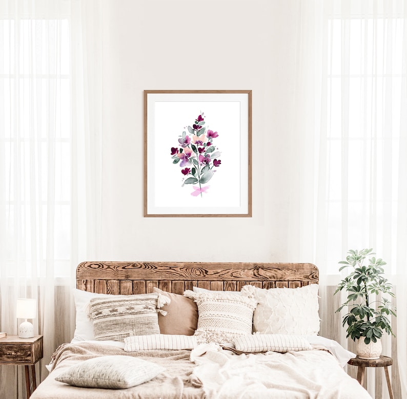 May include: A watercolour painting of a bouquet of purple and pink flowers with green leaves in a wooden frame.