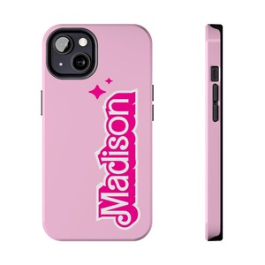 May include: Pink phone case with a white outline of the word "Madison" in pink letters and a few white stars.
