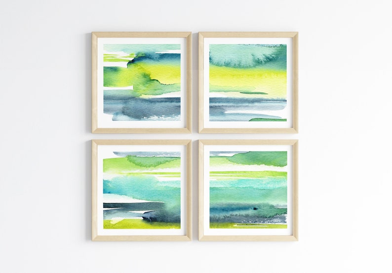 May include: Set of four abstract watercolor prints in shades of green, blue, and yellow. The prints are framed in natural wood frames and are arranged in a grid pattern.