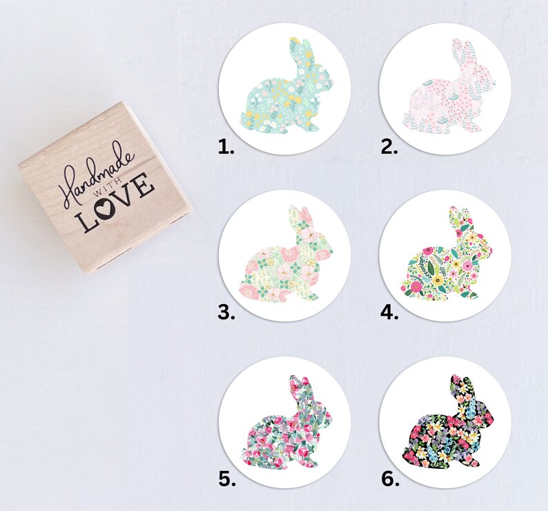 May include: Six round stickers with a floral bunny design. Each sticker features a different color scheme and floral pattern. The stickers are numbered 1 through 6.