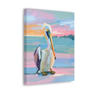 May include: A colourful painting of a pelican standing on a beach with a pink, blue and orange sunset in the background.