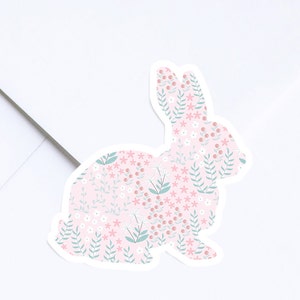 May include: A pink and green floral patterned bunny sticker. The bunny is facing the right side of the image.