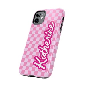 May include: Pink checkered phone case with the name Katherine written in a pink cursive font.