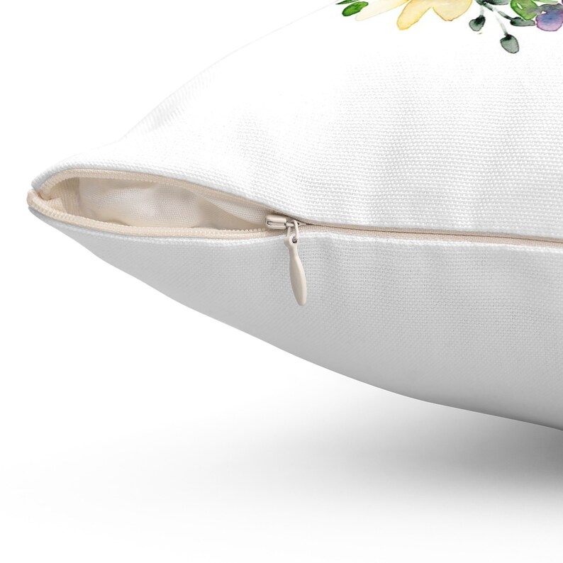 May include: White pillow cover with a zipper closure. The zipper is visible and open.