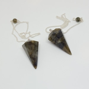 May include: Two silver chain pendulums with dark green and black labradorite crystal points.