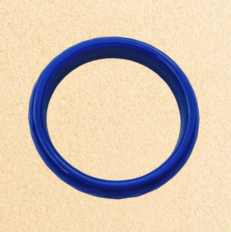 May include: A bright blue silicone ring, perfect for stacking or wearing alone.