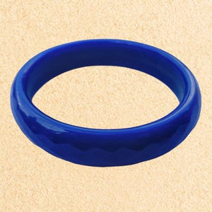 May include: A bright blue bangle bracelet with a smooth, glossy finish.