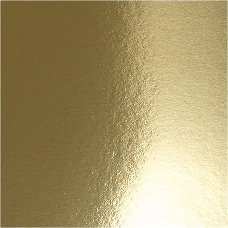 May include: A sheet of gold foil with a textured surface. The foil has a subtle sheen and a warm, metallic color.