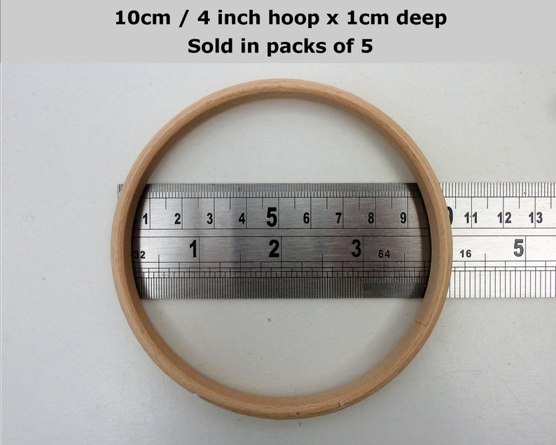 May include: A wooden embroidery hoop with a diameter of 4 inches or 10 centimeters. The hoop is 1 centimeter deep. The hoop is shown next to a ruler.