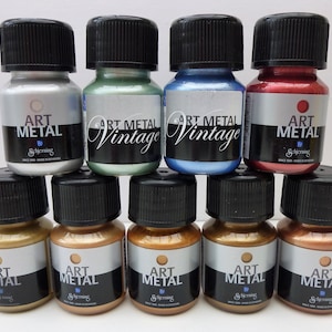 K&ouml;nnte beinhalten: Zehn kleine Flaschen mit Metallic-Farbe, beschriftet mit "Art Metal" in verschiedenen Farben, darunter Silber, Gr&uuml;n, Blau, Rot, Gold und Kupfer.