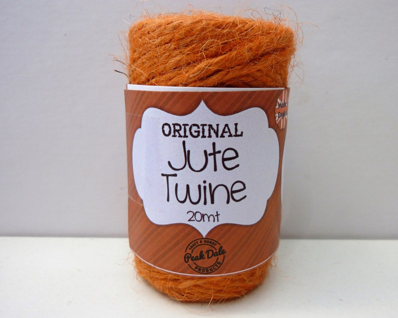 May include: A roll of orange jute twine with a label that reads "ORIGINAL Jute Twine 20mt" and "Peak Dale Products".