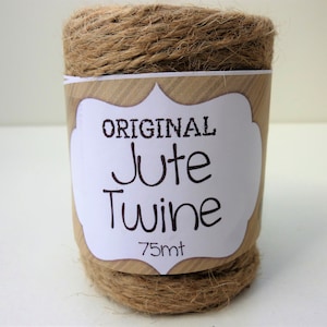 May include: A roll of natural brown jute twine with a white label that reads "ORIGINAL Jute Twine 75mt".