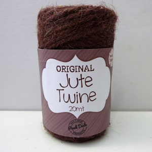 May include: A roll of brown jute twine with a white label that says "ORIGINAL Jute Twine 20mt" and a logo that says "Peak Dale Products".