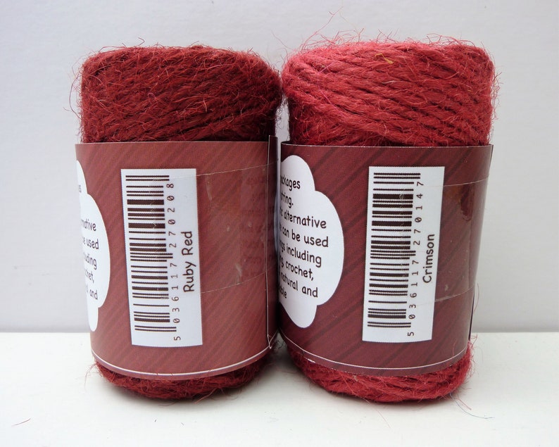 May include: Two spools of red twine, one labeled "Ruby Red" and the other "Crimson".