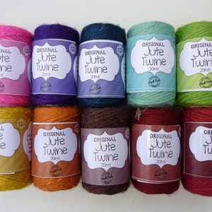 May include: Ten spools of natural jute twine, each 20 metres long, in a variety of colours including pink, purple, teal, green, yellow, orange, brown, red, and burgundy. The spools are labelled "Original Jute Twine 20mt".