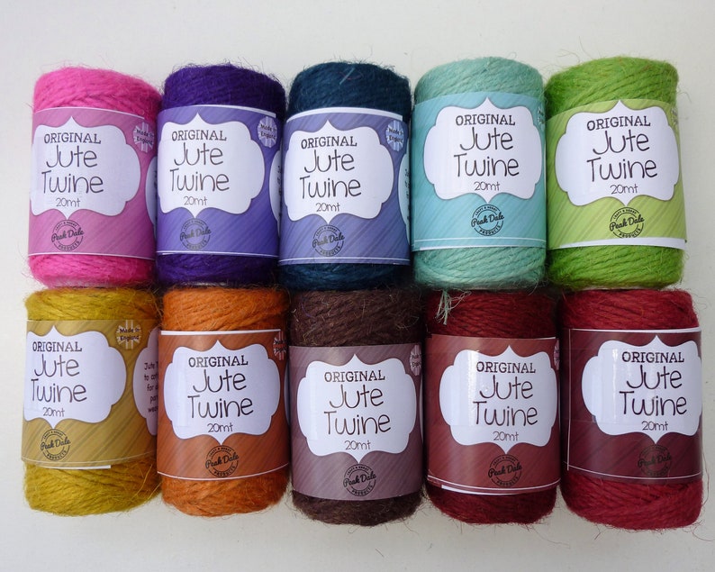 May include: Ten spools of natural jute twine, each 20 meters long, in a variety of colors including pink, purple, teal, green, yellow, orange, brown, red, and burgundy. The spools are labeled "Original Jute Twine 20mt".