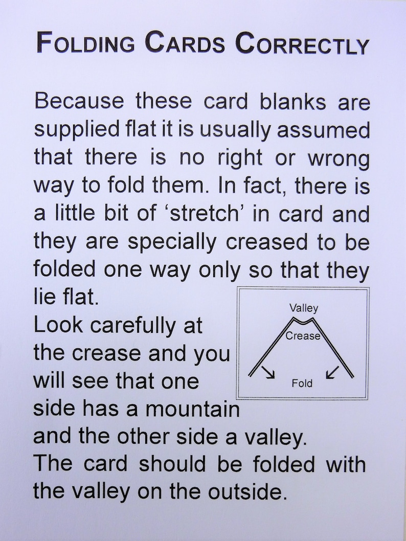 May include: A white sheet of paper with the title "FOLDING CARDS CORRECTLY" in black. The text explains how to fold cards, with a diagram showing the "valley" and "crease" of a card fold.