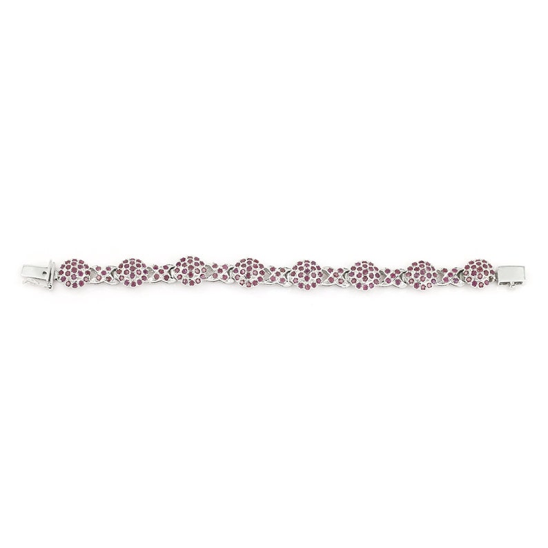 May include: A silver bracelet with a chain link design. Each link is set with small pink gemstones.