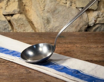 A stylish art-deco style stainless steel ladle / serving/ soup/ pasta spoon.