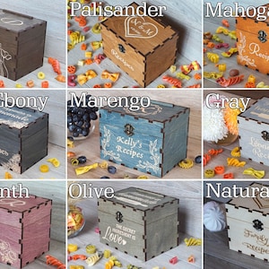 Pode incluir: Nove caixas de receitas de madeira em diferentes manchas de madeira, cada uma com um design e texto gravado diferente. As caixas est&atilde;o dispostas em tr&ecirc;s filas de tr&ecirc;s. A fila superior apresenta Wengu&eacute;, Palisandro e Mogno. A fila do meio apresenta &Eacute;bano preto, Marengo e Cinza. A fila inferior apresenta Amaranto, Oliva e Madeira natural.