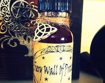 May include: A small glass bottle with a black cap and a brown label. The label has a decorative design and the text "Fiery Wall of Protection".