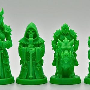 May include: A set of six green fantasy-themed figurines. The figurines include a horned figure, a robed figure, a figure with a staff, a figure riding a boar, a figure with a flag, and a figure with a sword. The figurines are made of plastic.