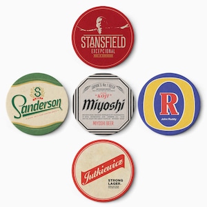 May include: Five round, colorful coasters with different designs and text. The coasters feature a variety of colors, including red, green, blue, and white. The text on the coasters includes the names of different brands, such as "Stansfield", "Sanderson", "Miyoshi", "Jutkiewicz", and "John Ruddy".
