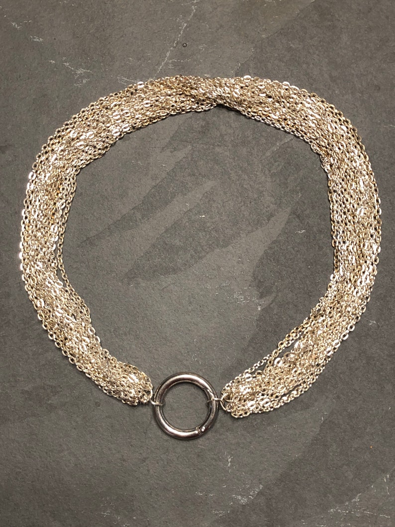Elegant multi strand day collar with steel ring clasp.