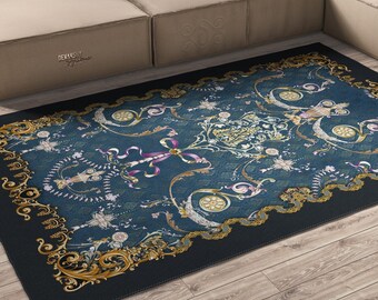 May include: A rectangular area rug featuring a deep blue center with an intricate gold and white filigree border. The design includes symmetrical floral motifs, swirling ribbons, and ornate scrollwork patterns across the dark blue surface.