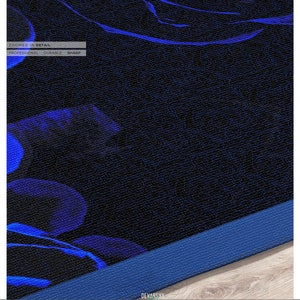 May include: A dark fabric featuring a vibrant blue floral pattern with a textured surface. The image includes text that reads ZOOMED IN DETAIL, PROFESSIONAL, DURABLE, SHARP, and DEVARSHY HOME, along with UPHOLSTERY, CURTAINS, BEDSHEETS, COMFORTERS, FABRICS, DUVET COVERS.