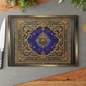 May include: Rectangular cutting board with a detailed, ornate design. The central panel is a deep blue, framed by gold filigree and a dark border. The design resembles a classical ceiling with intricate patterns.
