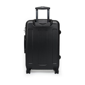 May include: Black hard-sided suitcase with a retractable handle and four wheels.