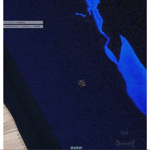 May include: A dark blue fabric with a textured surface and a bright blue abstract shape. The image includes the text: ZOOMED IN DETAIL, PROFESSIONAL, DURABLE, SHARP, DEVARSHY HOME LUXURY, UPHOLSTERY, CURTAINS, BEDSHEETS, COMFORTERS, FABRICS, DUVET COVERS.