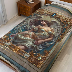 May include: A bedspread featuring a detailed illustration of a woman with angel wings, draped in flowing white fabric. The design is framed with ornate gold embellishments and set against a teal and beige background. The bedspread is on a wooden bed frame.