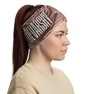 May include: A brown and tan headband with a white graphic design that says "DEVARSHAY".