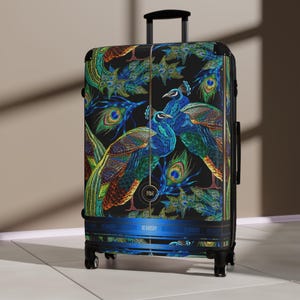 May include: A black upright suitcase featuring a vibrant peacock pattern with shades of blue, green, and gold. The luggage has a retractable handle, four spinner wheels, and a horizontal blue band at the base with the text Devarshy printed repeatedly.