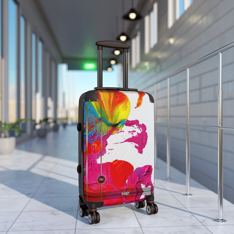 Abstract art hard shell suitcase featuring vibrant splashes of pink, red, yellow, orange, and blue on a glossy white background. Modern spinner luggage for creative travelers, perfect as a gift for artists and color lovers. Stylish carry-on suitcase with bold, unique painting-inspired design, ideal for holidays, business trips, and fashion-forward journeys. Durable, lightweight case blends contemporary aesthetics with bright pop art energy for men and women.