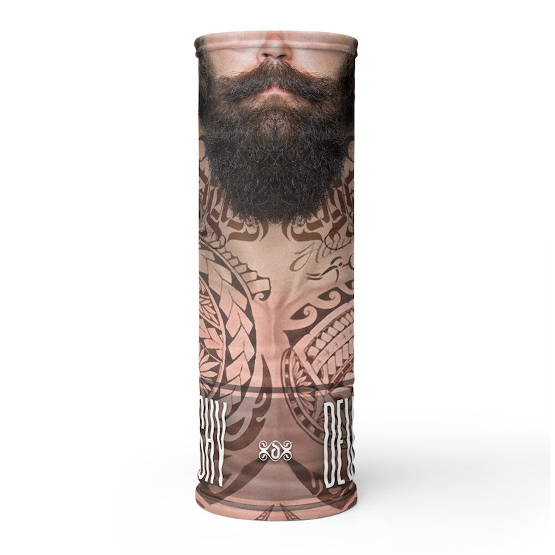 May include: A brown and tan face mask with a tribal design and a bearded man's face. The text "SHY DEVIL" is printed on the mask.