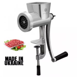 May include: A silver-colored, manual meat grinder with a black handle and clamp. The grinder is shown with a tray of ground meat, tomatoes, and lettuce. The text "MADE IN UKRAINE" is displayed in black.