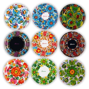 May include: Nine decorative plates with floral designs. Each plate features a unique pattern of flowers and leaves in vibrant colors like blue, red, yellow, and green. Some plates have a central text element.