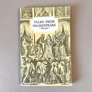 May include: A vintage book titled "Tales From Shakespeare" with a cream-colored cover. The cover features a black and white illustration of a stage scene with figures in period clothing and the title in a decorative frame.