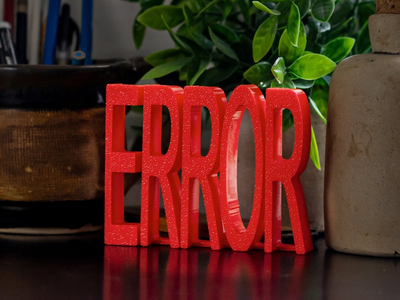 May include: Red plastic letters spelling out the word "ERROR" on a dark surface.