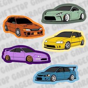May include: A collection of five car stickers in various colors. The stickers feature illustrations of different car models, including a green coupe, a yellow hatchback, a purple coupe, an orange hatchback, and a blue sedan with a spoiler.