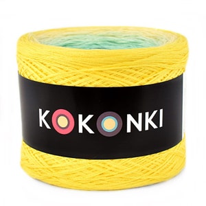 May include: A yellow ball of yarn with a green and white ombre effect. The yarn is labeled "KOKOONKI" with a colorful logo.