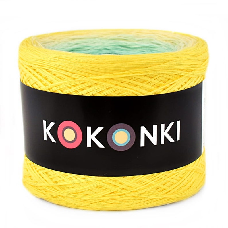 May include: A yellow ball of yarn with a green and white ombre effect. The yarn is labeled "KOKOONKI" with a colorful logo.