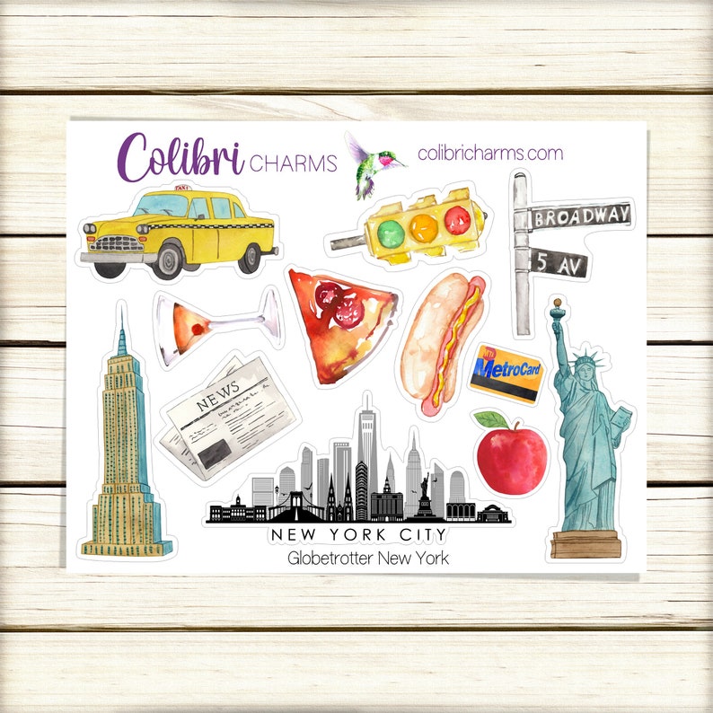 May include: A set of 10 watercolor stickers featuring iconic New York City imagery, including a yellow taxi cab, a slice of pizza, a hot dog, a martini glass, a newspaper, the Empire State Building, the Statue of Liberty, a red apple, a traffic light, and a street sign with "Broadway" and "5 Av" written on it. The stickers are arranged on a white background with the text "Colibri CHARMS" and "collricharms.com" at the top. The text "NEW YORK CITY" and "Globetrotter New York" is at the bottom.