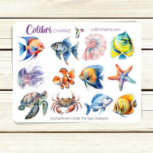 May include: A sheet of stickers featuring watercolor illustrations of sea creatures, including a jellyfish, a sea turtle, a crab, a starfish, a seashell, and various fish. The stickers are white with a blue border and the text "Enchantment Under the Sea Creatures" at the bottom.