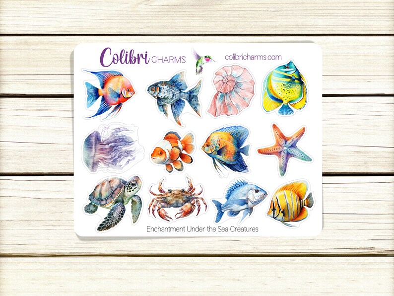 May include: A sheet of stickers featuring watercolor illustrations of sea creatures, including a jellyfish, a sea turtle, a crab, a starfish, a seashell, and various fish. The stickers are white with a blue border and the text "Enchantment Under the Sea Creatures" at the bottom.