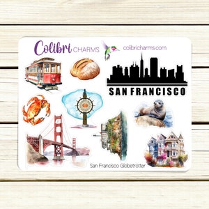 May include: A sheet of stickers featuring various San Francisco landmarks, including the Golden Gate Bridge, a cable car, a sourdough loaf, and a sea lion. The stickers are printed on white paper with a watercolor-style design. The text "San Francisco Globetrotter" is printed at the bottom of the sheet.